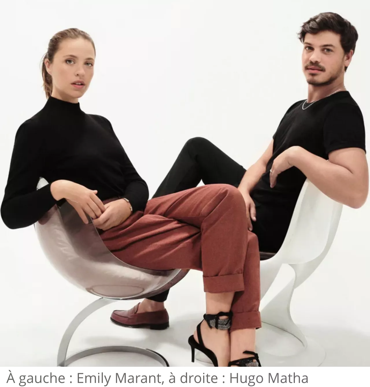 The two members of French Cliché, the duo composed of Emily Marant on the left and Hugo Matha on the right sitting on white chairs
